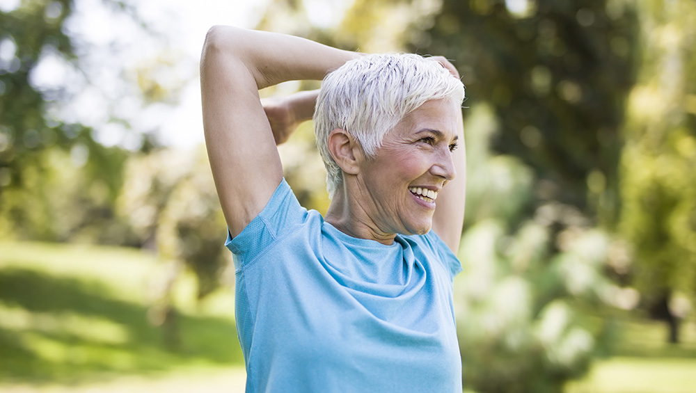 A senior woman stretching her arms