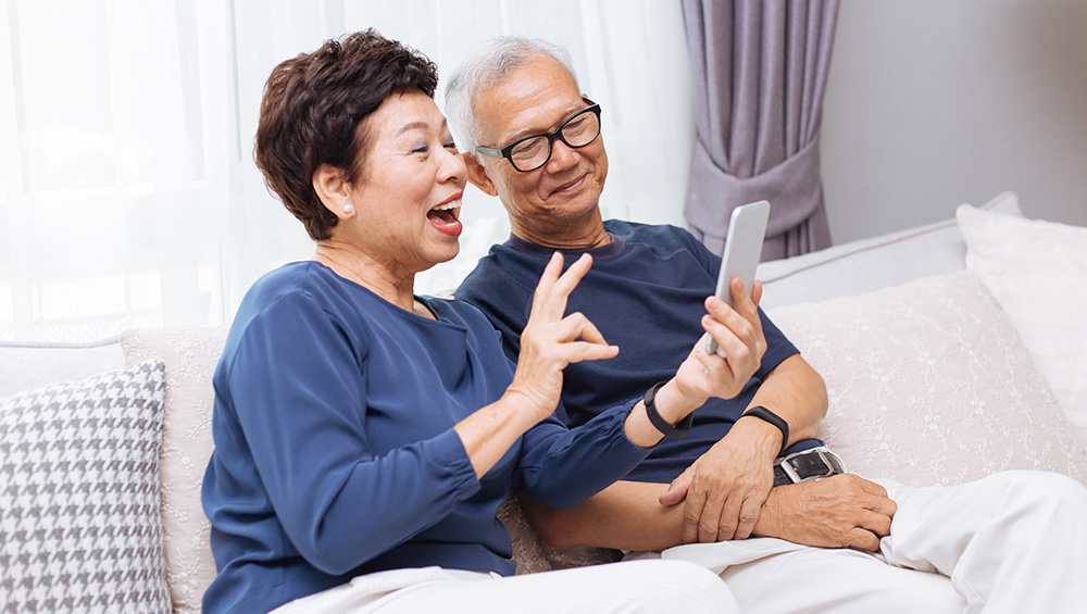 A senior couple on their phone