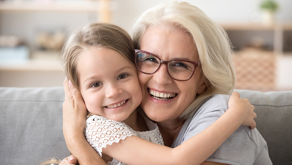A grandmother hugging her granddaughter